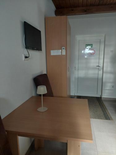 a room with a wooden table and a door at Apartment M&M in Pačir