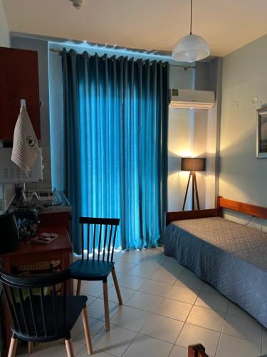 a bedroom with a bed and a desk and a table and chairs at Bella Vista in Balíon
