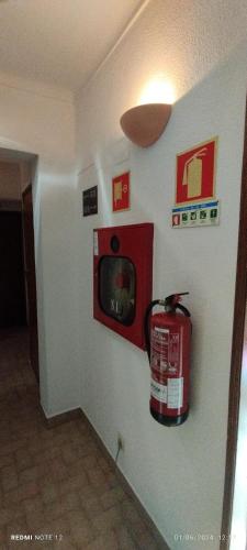 a fire hydrant is on a wall with a microwave at Hotel Alnacir in Faro