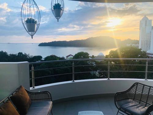 a balcony with two benches and a view of the water at 06F Resort Breathtaking Ocean Views Panama Canal in Panama City