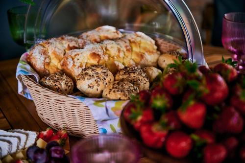 a basket of pastries on a table next to a bowl of fruit at Slow Orzechów in Sosnowica