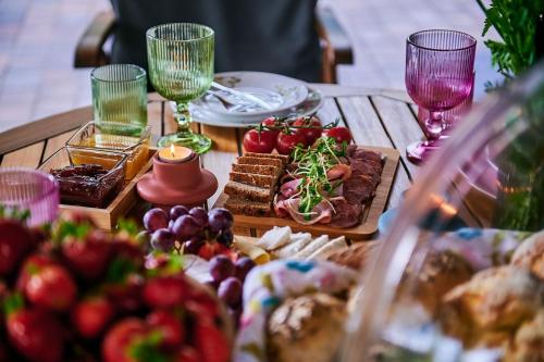 a table topped with food and wine glasses at Slow Orzechów in Sosnowica