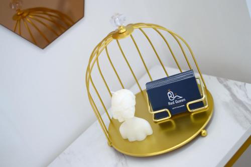 a gold bird cage with a book and cotton balls at Red Queen Herculaneum in Ercolano