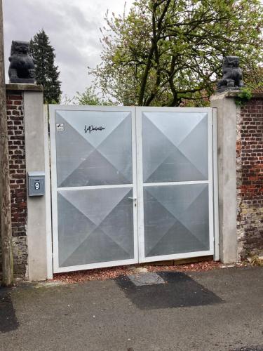 a large glass door with the word hyannis written on it at Tiny House Le Poulailler in Bousbecque