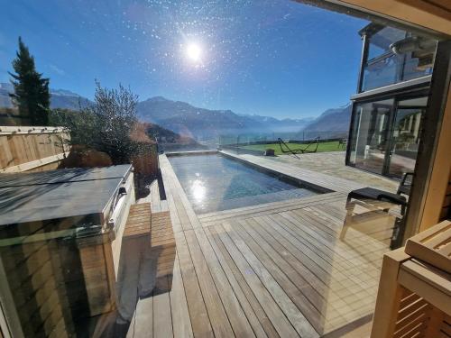a pool on a deck with a view of the mountains at Studio Le Carnotzet Tchiko minimum 2 nights Special weekly and monthly prices in Savièse