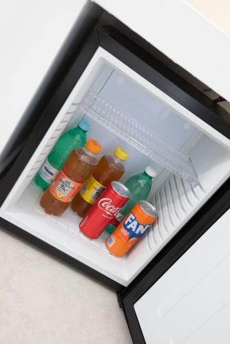 an open refrigerator filled with soda and drinks at Red Queen Herculaneum in Ercolano