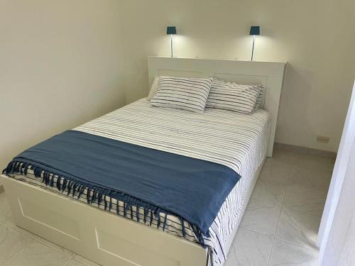 a bed in a bedroom with two pillows on it at La casa al mare in Ostuni Costa Merlata