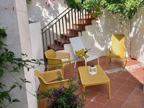 a group of chairs and tables on a patio at La casa al mare in Ostuni Costa Merlata