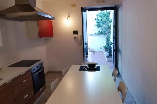 a kitchen with a table and a view of a yard at La casa al mare in Ostuni Costa Merlata