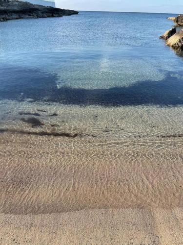 a body of water with ripples on the beach at La casa al mare in Ostuni Costa Merlata