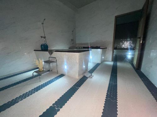 a room with a swimming pool with two chairs and a table at HAMILTON Agadir in Agadir
