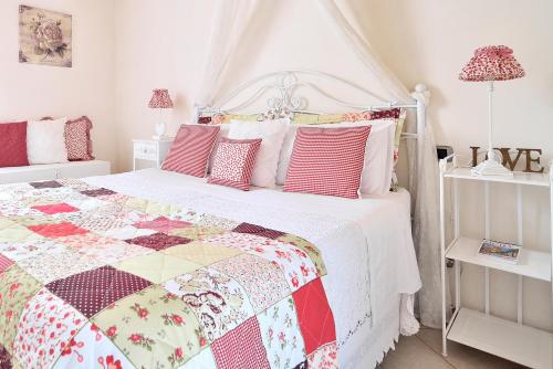 a bedroom with a bed with a quilt on it at Case del Vicolo Stretto in Modica