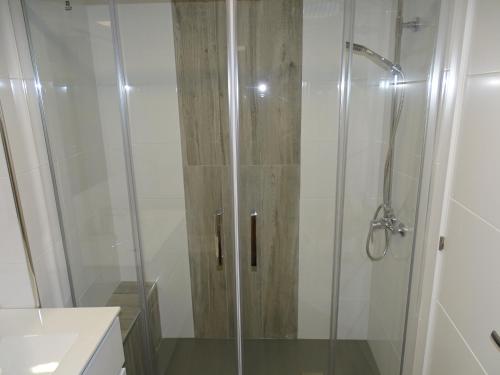 a shower with a glass door in a bathroom at A casa da Abunana in Cangas de Morrazo