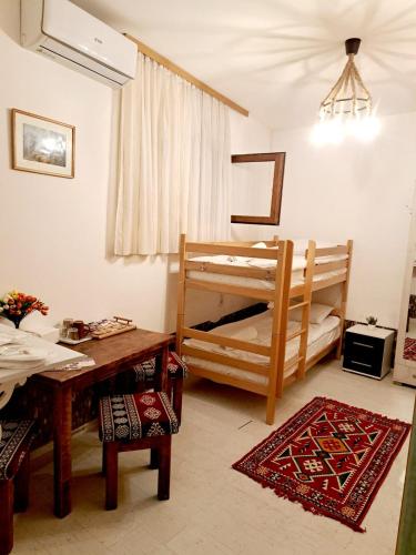 a living room with a table and a bunk bed at Sebilhan Apart Hotel in Sarajevo