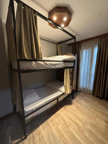 two bunk beds in a room with a window at Moon Hostel in Istanbul