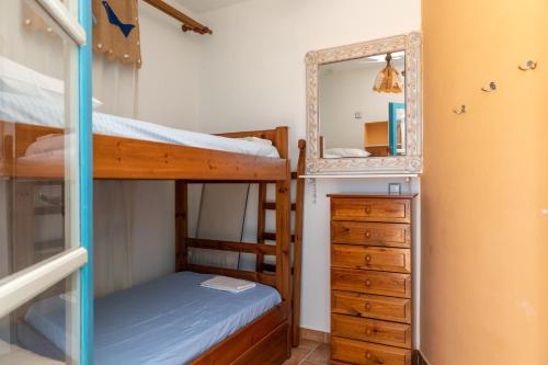a bedroom with two bunk beds and a mirror at mikri vigla eksohiki katoikia in Mikri Vigla