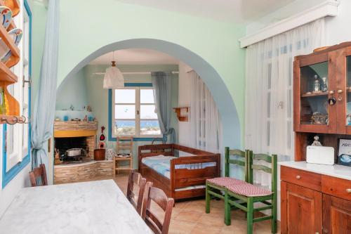 a bedroom with a bed and a table and chairs at mikri vigla eksohiki katoikia in Mikri Vigla