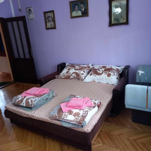 a bed in a room with two towels on it at Smestaj VELjKOVIC in Bela Crkva