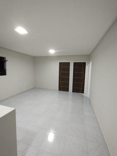 an empty room with white walls and white tile floors at Condomínio Tribu 02 in Caruaru