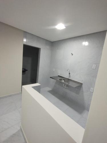a bathroom with a sink in a white room at Condomínio Tribu 02 in Caruaru