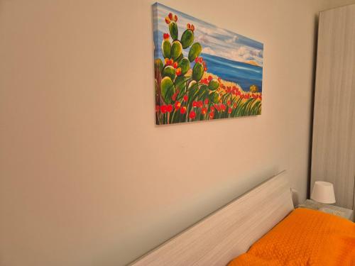 a painting of flowers on the wall of a bedroom at A casa di Antonella - Via Tagliamento in Portopalo