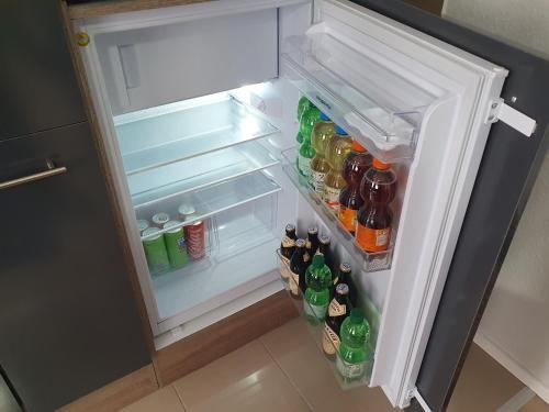 an open refrigerator filled with lots of drinks at Apartement Weingarten in Weingarten