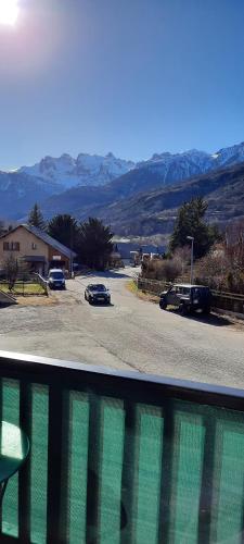 a view from a balcony of a parking lot with cars at Charmant Studio Briançon in Briançon