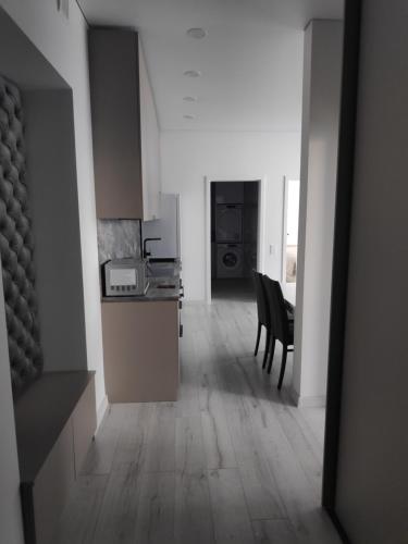 a kitchen and dining room with a table and chairs at Aušros Alėjos Apartamentai in Šiauliai