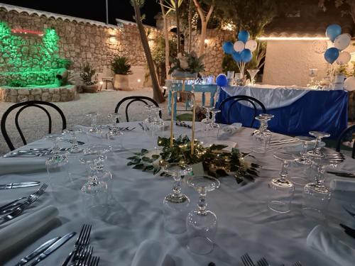 a table with wine glasses and balloons on it at Villabosco in Favara
