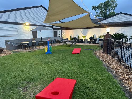 a backyard with a picnic table and an umbrella at At Home Inn - Pensacola in Pensacola