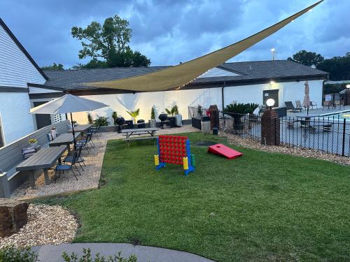 a backyard with a picnic table and a playground with a tent at At Home Inn - Pensacola in Pensacola