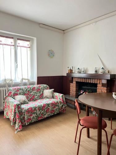 a living room with a couch and a table at Alta Valle Intelvi LA MARINELLA in Lanzo dʼIntelvi