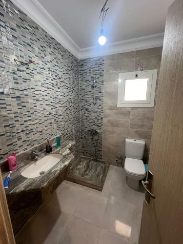 a bathroom with a sink and a toilet at ابراج الداون تاون العلمين الجديده Luxury Apartment In Downtown New Alamein in Ad Darāzīyah