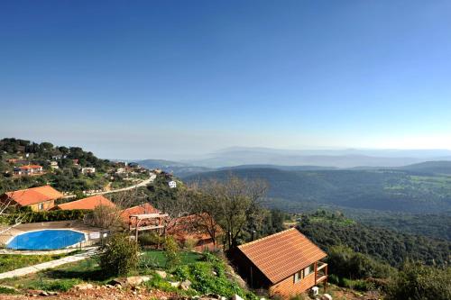 a house on a hill with a swimming pool at לוין נוף מרהיב in Amirim