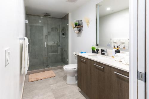 a bathroom with a shower and a toilet and a sink at Vibrant Downtown Miami Gem - 2BR, near Port of Miami & Entertainment in Miami