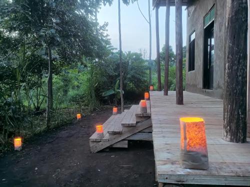 eine Gruppe Kerzen auf einer Holzterrasse in der Unterkunft Kibale Tented Camp in  Kibale Forest National Park