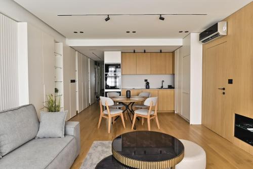 a living room with a couch and a table at Belgrade City Escape - Genex in Belgrade
