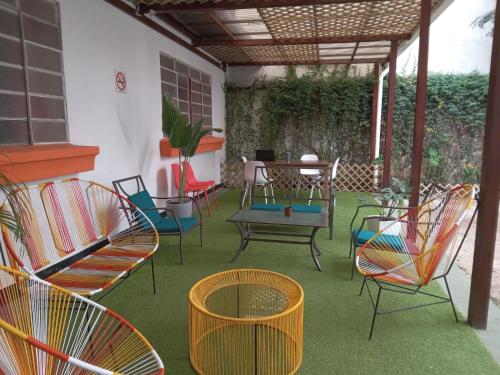 a group of chairs and a table on a patio at Tequila Sunrise Hostel in Guatemala