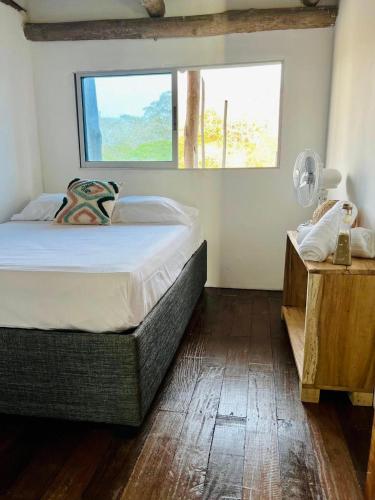 a bedroom with a large bed and a window at Itaca Eco House in Playa Blanca