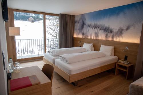 Postel nebo postele na pokoji v ubytování Hotel Stump's Alpenrose