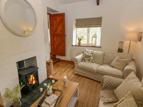 a living room with a couch and a fireplace at The Stables in Haverfordwest