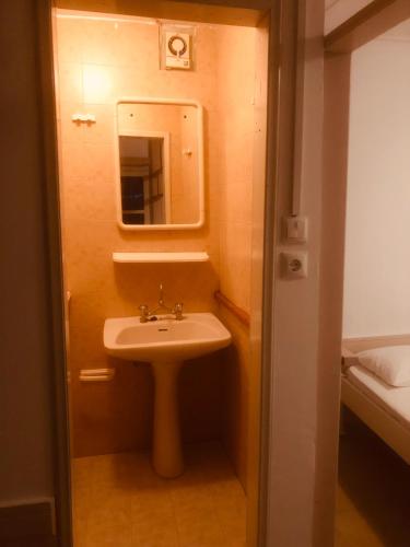 a small bathroom with a sink and a mirror at Barreira Beachfront Rooms 4 in Kalamata