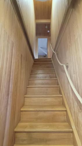 a staircase in a building with wooden walls and wooden floors at Chalet 12 places dans le Vercors in Corrençon-en-Vercors