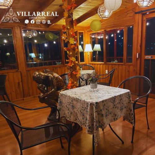 a dining room with a table and a statue at Villarreal Lodge Hotel Ecológico in Totolapan