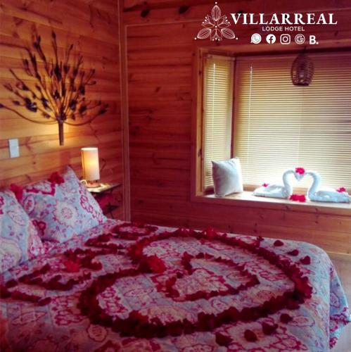 a bed with a heart made out of flowers on it at Villarreal Lodge Hotel Ecológico in Totolapan