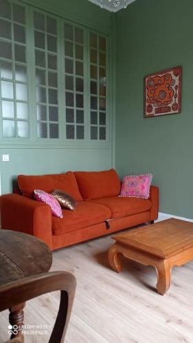 a living room with a red couch and a table at Studio 18 Résidence du Parc in Châtel-Guyon