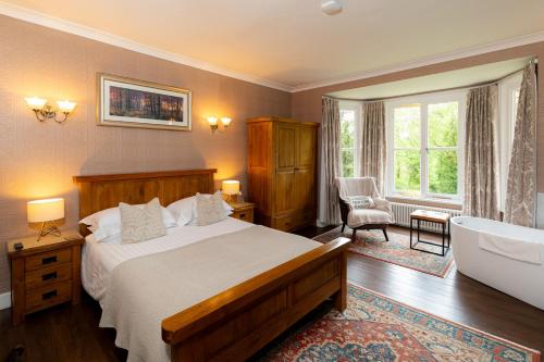 a bedroom with a large bed and a bath tub at Coalbrookdale Villa in Ironbridge