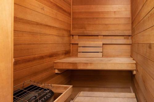 a sauna with wooden walls and a wooden bench at Beachfront Bliss-Phoenix II in Orange Beach