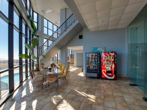 a dining area with a soda machine in a building at Beachfront Bliss-Phoenix II in Orange Beach