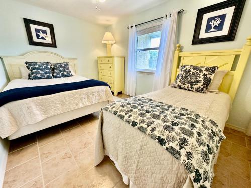 a bedroom with two beds and a window at Sandcastles and Sunshine - Gulf Highlands Beach Resort in Panama City Beach